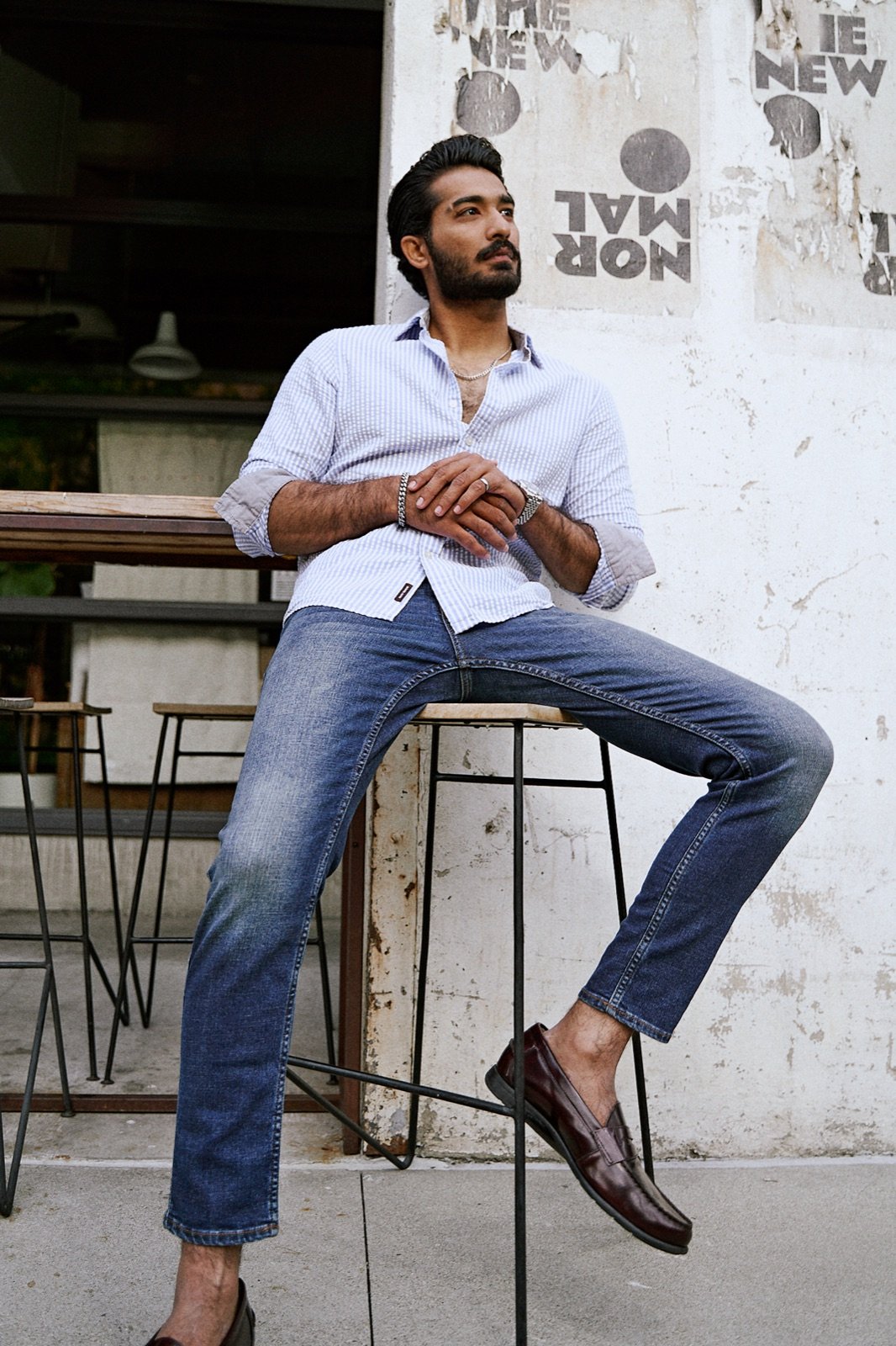 On a bar stool, leather loafers