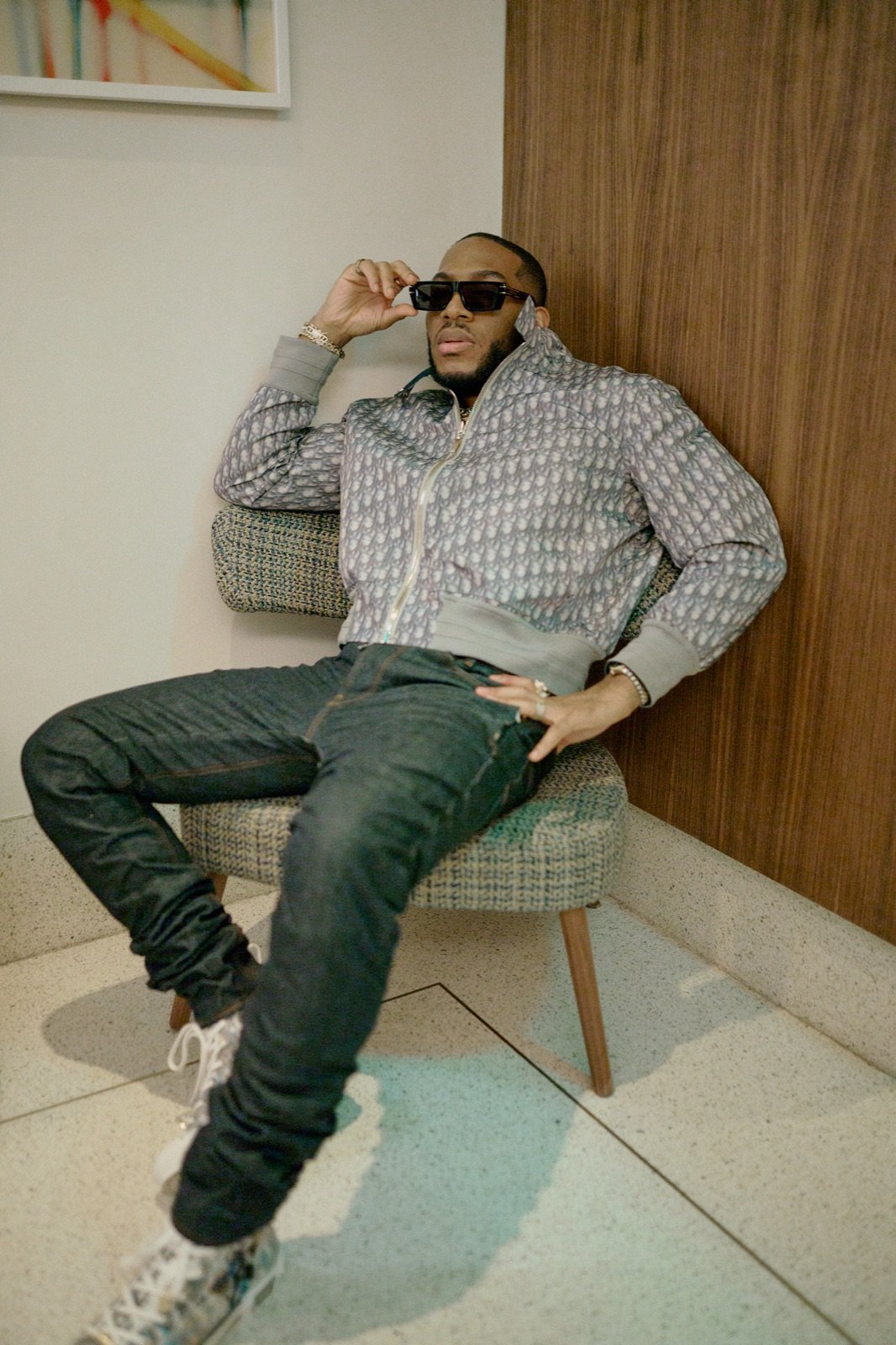 Patterned jacket and sunglasses in a lounge chair