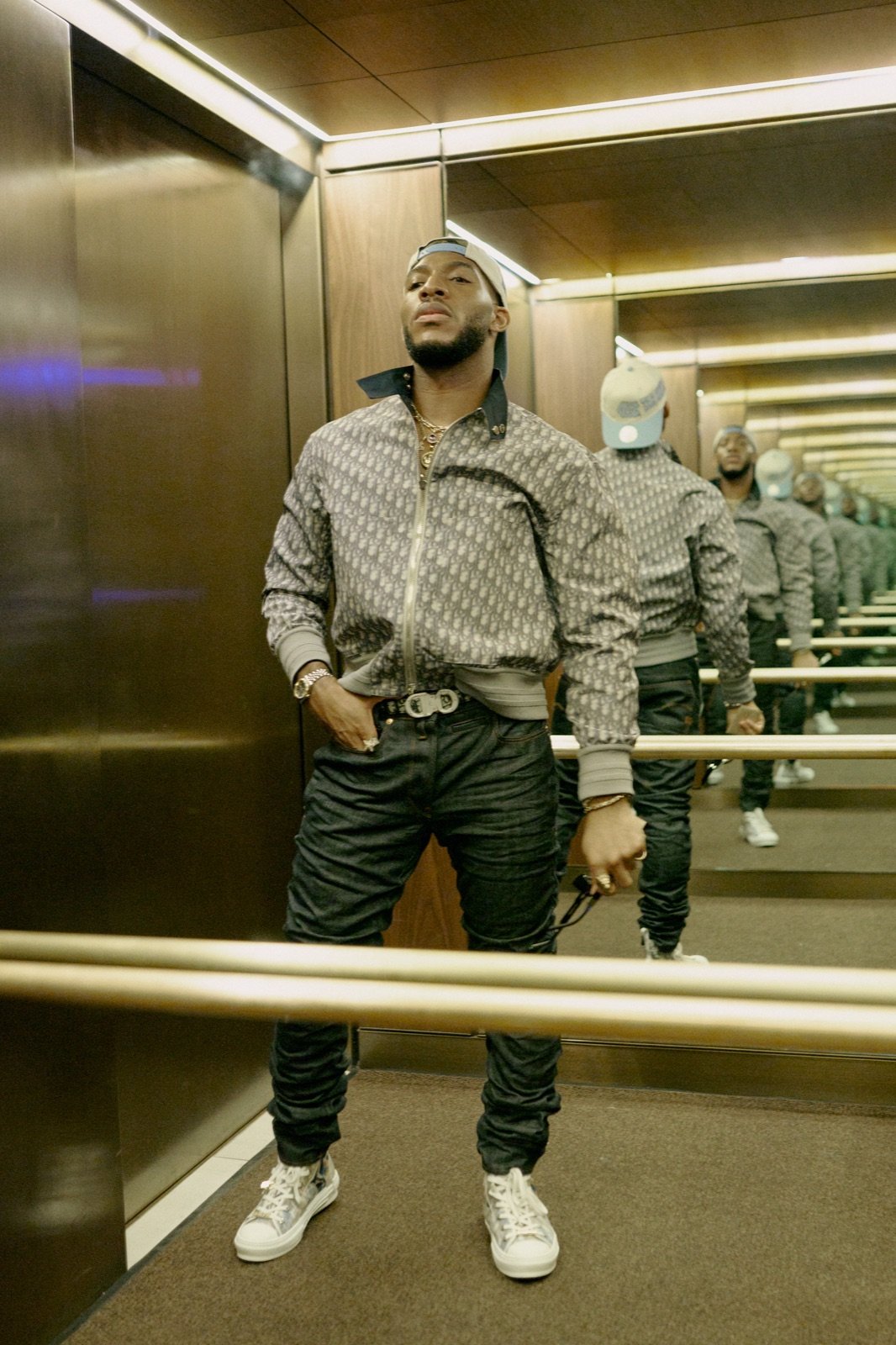 Patterned jacket in a mirrored elevator