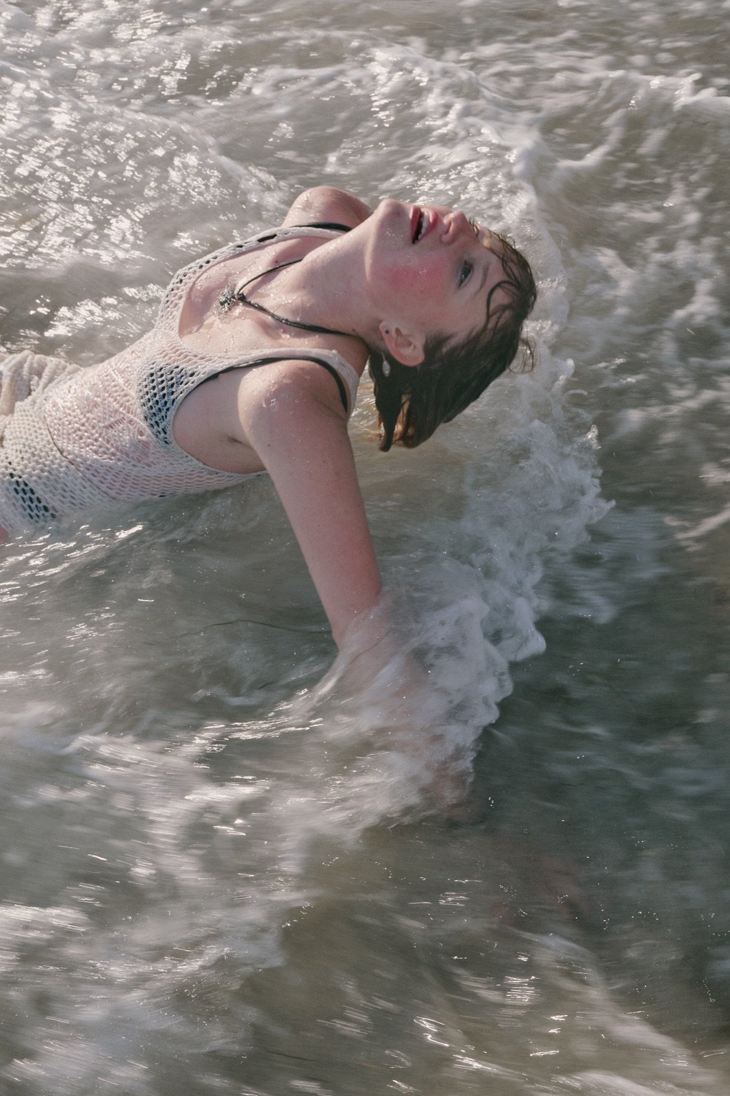 Crochet dress in the surf