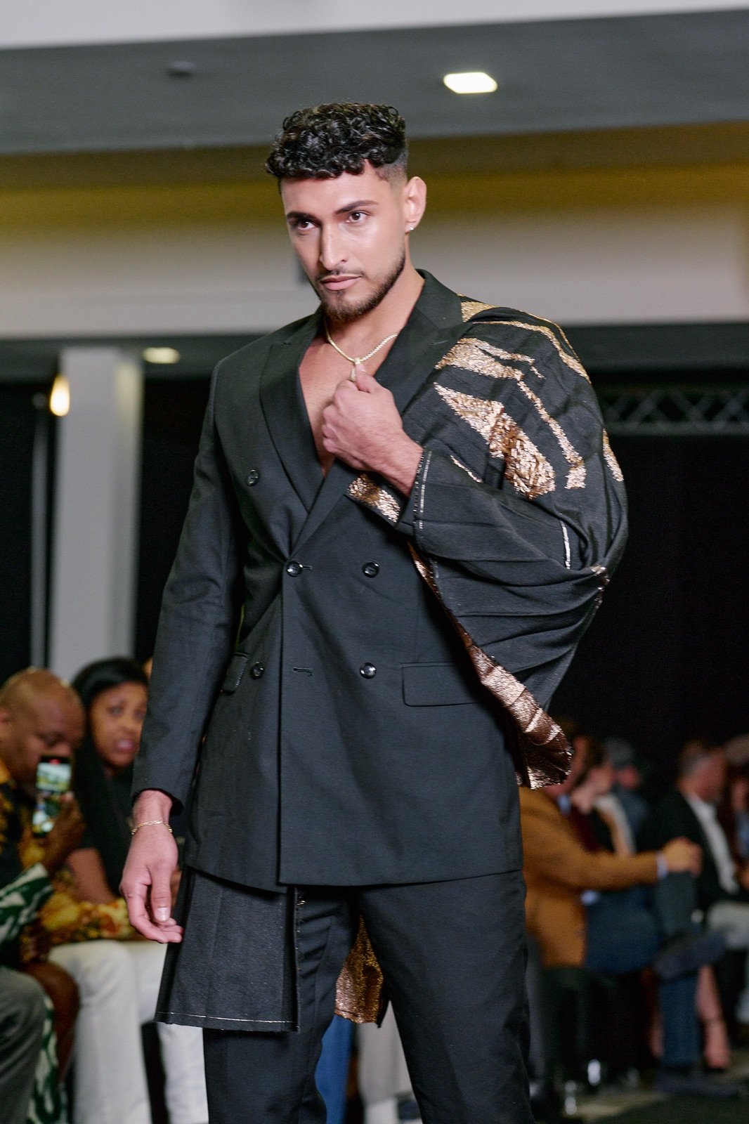 Black suit with a draped print sash