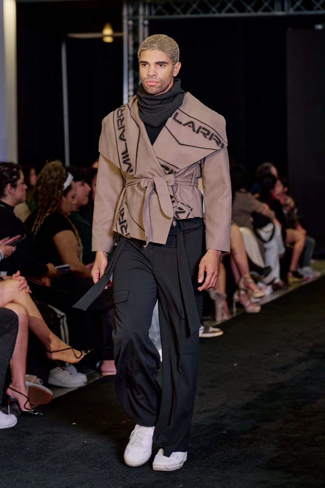 Belted tan jacket and black scarf
